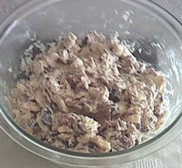 Folding in remaining ingredients to make soft chocolate chip cookies