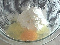 Adding egg, one at a time, to start a dough for raivas