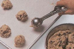 portioning cookie dough by scooping for quick and easy recipes